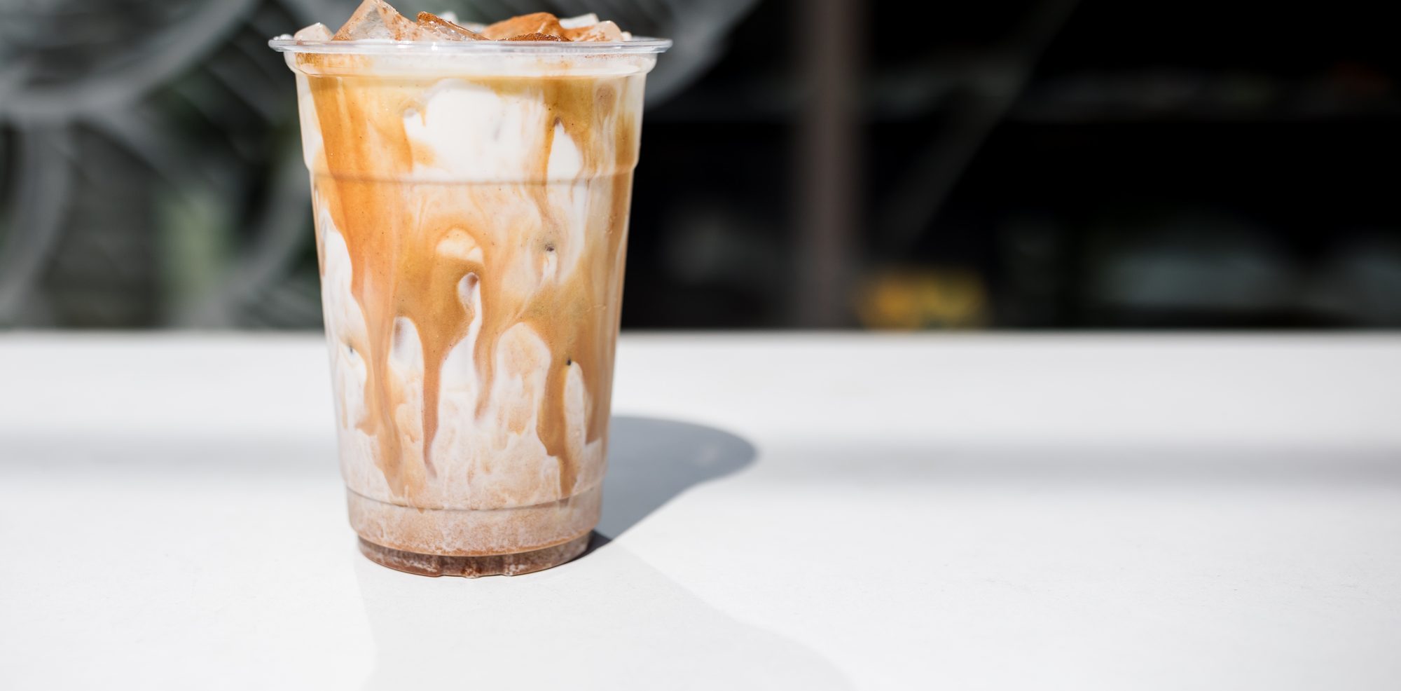 Iced cinnamon latte in a clear cup at an E+ROSE cafe