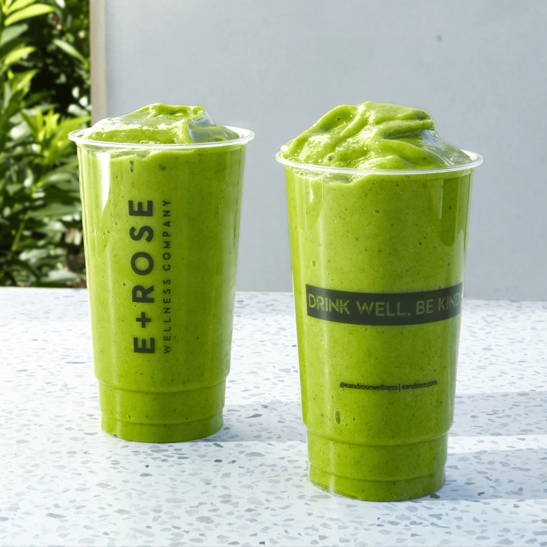Two E+ROSE green smoothies in branded cups